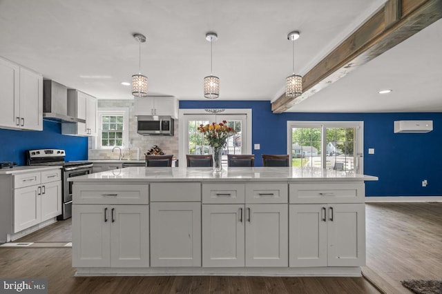 1039 Clinton Ave, Bensalem, PA 19020 - kitchen with appliances with stainless steel finishes, wall chimney exhaust hood, white cabinetry, decorative backsplash, and healthy amount of natural light