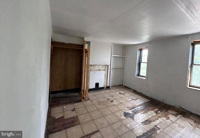 324 Fulton Ave, Baltimore, MD 21223 - unfurnished bedroom with multiple windows