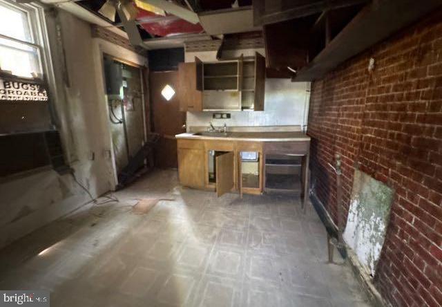 324 Fulton Ave, Baltimore, MD 21223 - kitchen with brick wall and open shelves