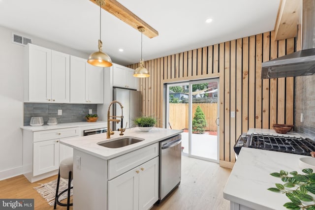 2165 E Gordon St, Philadelphia, PA 19125 - kitchen with stainless steel dishwasher, decorative backsplash, range hood, white cabinetry, and recessed lighting