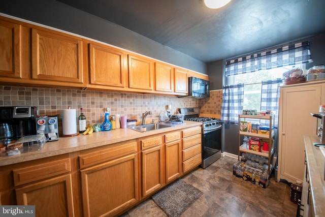 5563 Cedonia Ave, Baltimore, MD 21206 - kitchen featuring gas stove, black microwave, backsplash, light countertops, and brown cabinetry