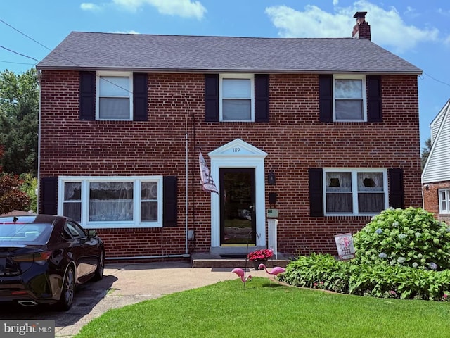 1119 Rte 70 W, Cherry Hill, NJ 08002 - view of front facade with brick siding, a chimney, a shingled roof, and a front lawn