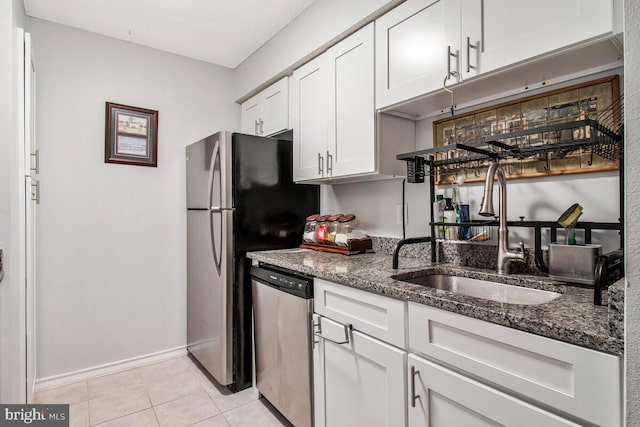 1515 Lincoln Way Unit 304B, Mclean, VA 22102 - kitchen with stainless steel appliances, dark stone counters, white cabinets, and light tile patterned flooring