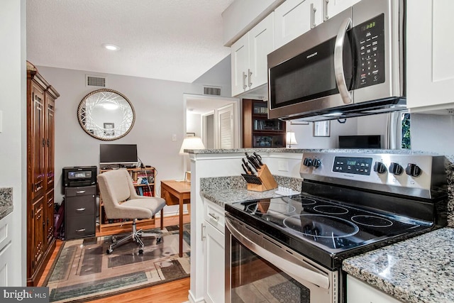1515 Lincoln Way Unit 304B, Mclean, VA 22102 - kitchen featuring stainless steel appliances, white cabinetry, light stone countertops, and light wood-type flooring