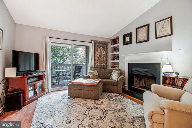 1515 Lincoln Way Unit 304B, Mclean, VA 22102 - living area featuring a fireplace with flush hearth, wood finished floors, and lofted ceiling