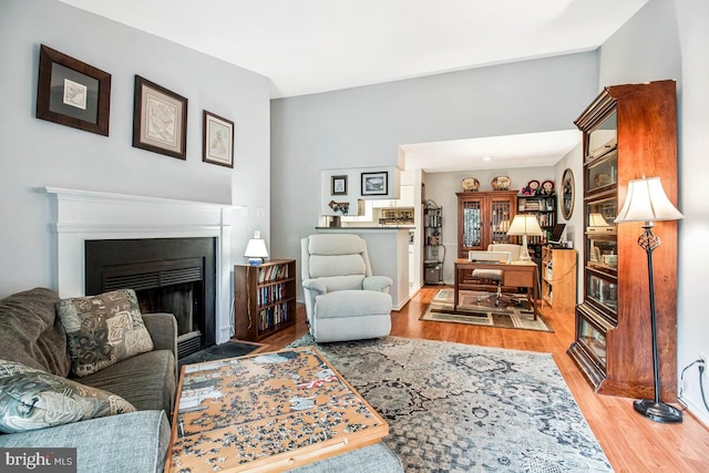 1515 Lincoln Way Unit 304B, Mclean, VA 22102 - living area featuring wood finished floors and a fireplace with flush hearth