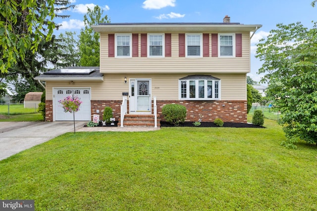 2028 S Olden Ave, Hamilton, NJ 08610 - colonial house with brick siding, a garage, driveway, solar panels, and a chimney