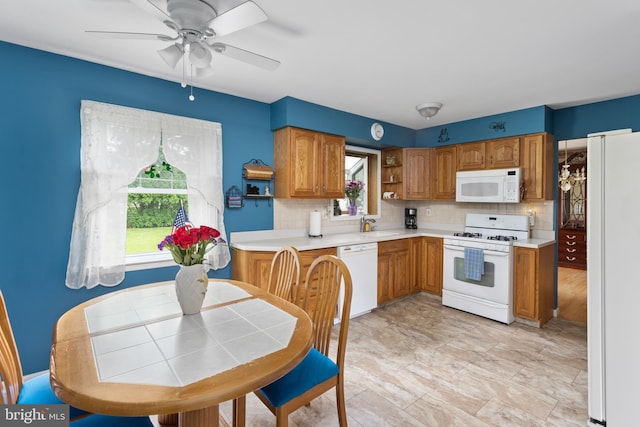 2028 S Olden Ave, Hamilton, NJ 08610 - kitchen with white appliances, tasteful backsplash, and brown cabinetry