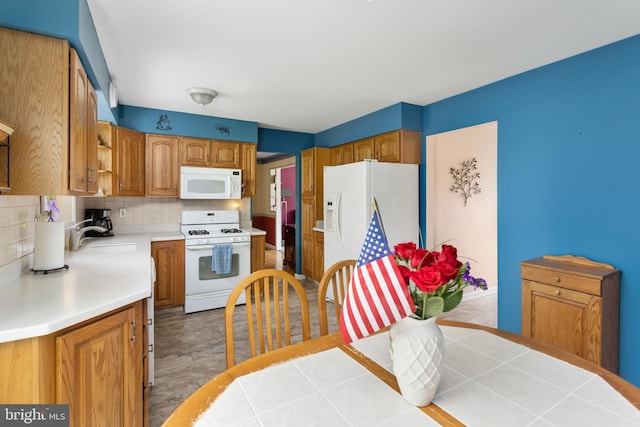 2028 S Olden Ave, Hamilton, NJ 08610 - kitchen with white appliances, light countertops, decorative backsplash, and brown cabinets
