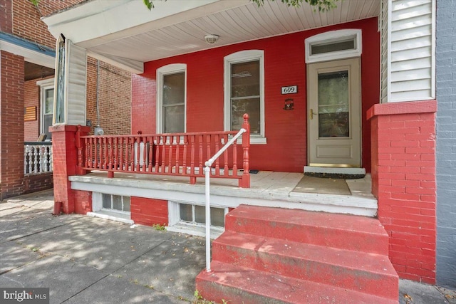 609 E Chestnut St, Lancaster, PA 17603 - property entrance featuring a porch and brick siding