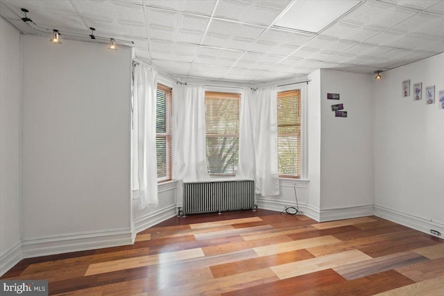 609 E Chestnut St, Lancaster, PA 17603 - spare room featuring radiator heating unit and wood finished floors