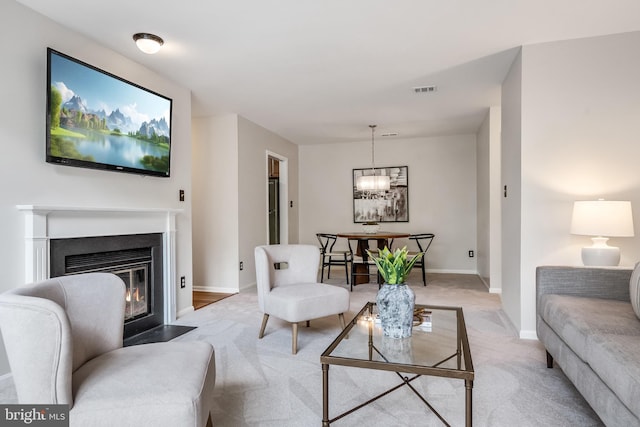 2810 Lee Oaks Pl Unit 302, Falls Church, VA 22046 - living area with a chandelier, light colored carpet, and a fireplace with flush hearth