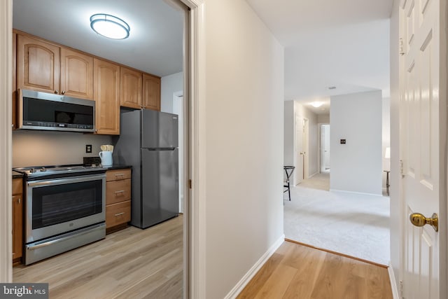 2810 Lee Oaks Pl Unit 302, Falls Church, VA 22046 - kitchen with appliances with stainless steel finishes, light wood-style flooring, and dark countertops