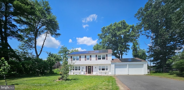 1 Helm Turn, Willingboro, NJ 08046 - colonial-style house with an attached garage, solar panels, a front yard, and asphalt driveway