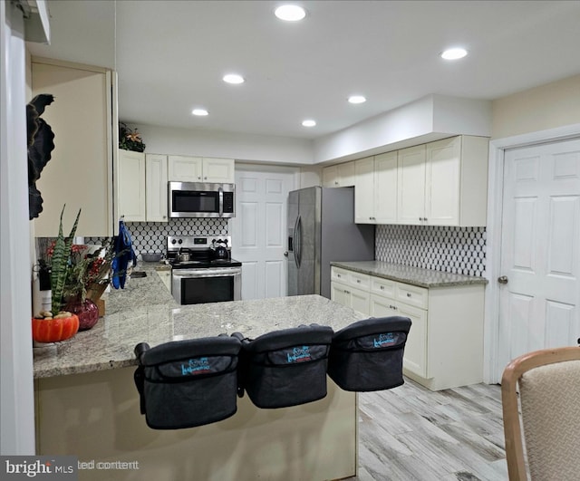 1 Helm Turn, Willingboro, NJ 08046 - kitchen with appliances with stainless steel finishes, light wood-style floors, tasteful backsplash, white cabinets, and recessed lighting