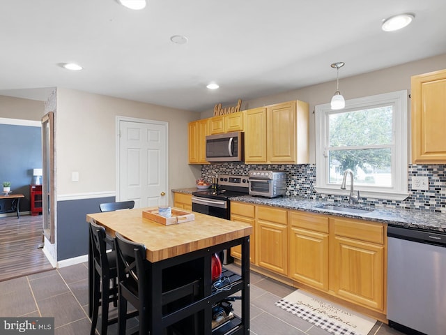 102 W Keystone Ave, Wilmington, DE 19804 - kitchen with stainless steel appliances, decorative backsplash, light brown cabinets, recessed lighting, and butcher block counters