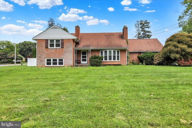 3225 Eisenbrown Rd, Reading, PA 19605 - back of property featuring brick siding, a yard, and a chimney