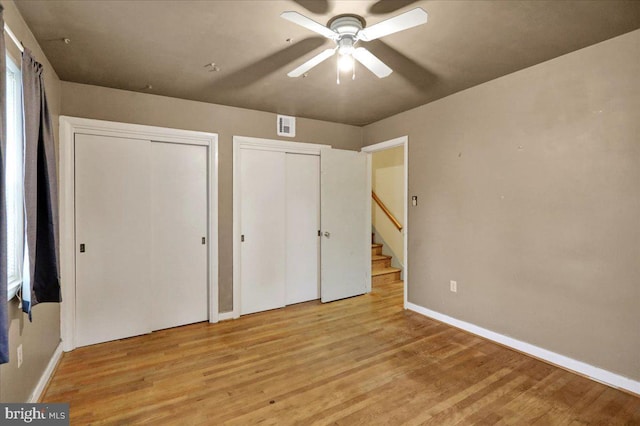 3225 Eisenbrown Rd, Reading, PA 19605 - unfurnished bedroom with two closets, wood finished floors, and a ceiling fan