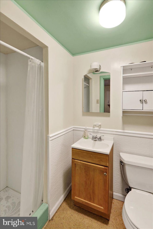 3225 Eisenbrown Rd, Reading, PA 19605 - bathroom with tile walls, vanity, wainscoting, and a shower with shower curtain