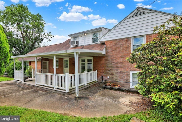 3225 Eisenbrown Rd, Reading, PA 19605 - view of front of property featuring brick siding, a porch, and cooling unit