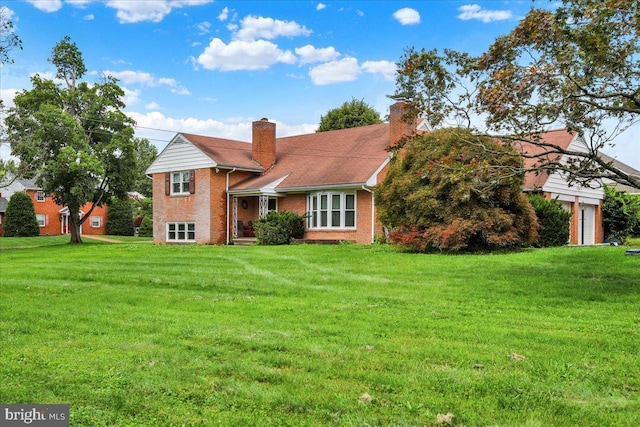 3225 Eisenbrown Rd, Reading, PA 19605 - split level home with brick siding, a chimney, and a front lawn