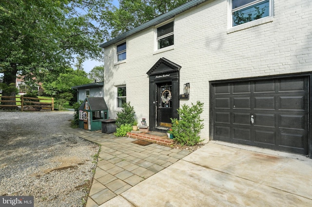 1900 Philadelphia Pike, Claymont, DE 19703 - view of front of home with concrete driveway, brick siding, and a garage