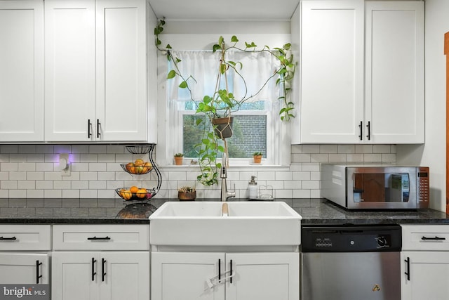 1900 Philadelphia Pike, Claymont, DE 19703 - kitchen featuring appliances with stainless steel finishes, white cabinetry, backsplash, and dark stone counters