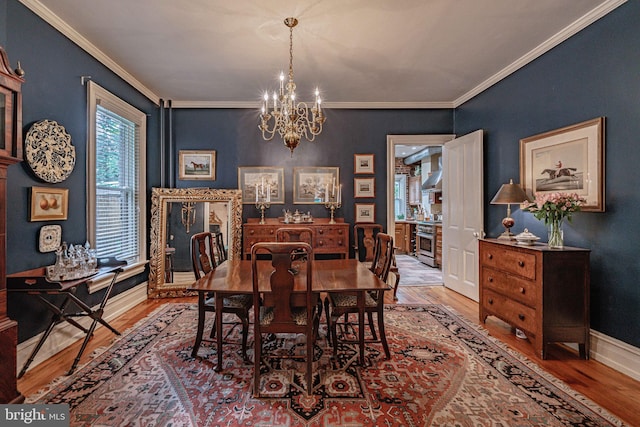 407 N 8th St, Allentown, PA 18102 - dining area with wood finished floors, a chandelier, and crown molding