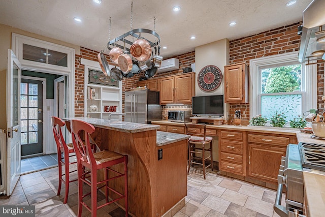 407 N 8th St, Allentown, PA 18102 - kitchen with high end fridge, a kitchen island, recessed lighting, backsplash, and a wall unit AC