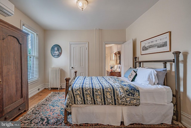 407 N 8th St, Allentown, PA 18102 - bedroom with radiator, a wall mounted air conditioner, and light wood finished floors