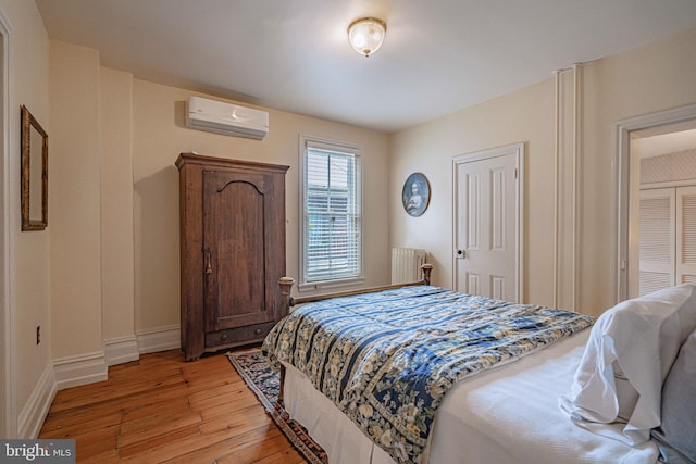 407 N 8th St, Allentown, PA 18102 - bedroom featuring a wall unit AC, radiator, and light wood-type flooring