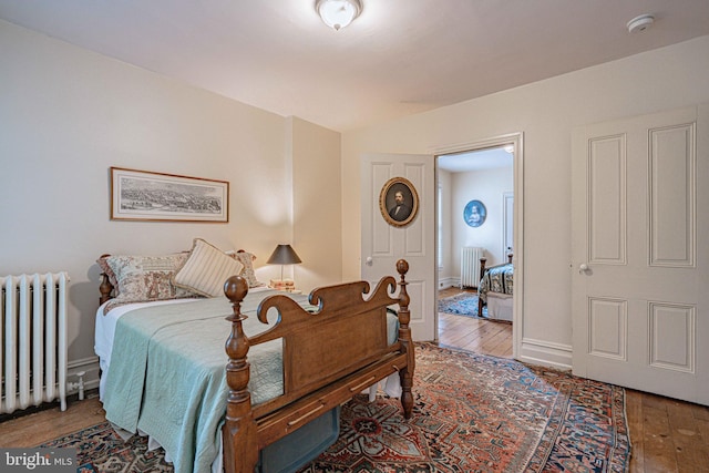 407 N 8th St, Allentown, PA 18102 - bedroom with radiator heating unit and hardwood / wood-style floors