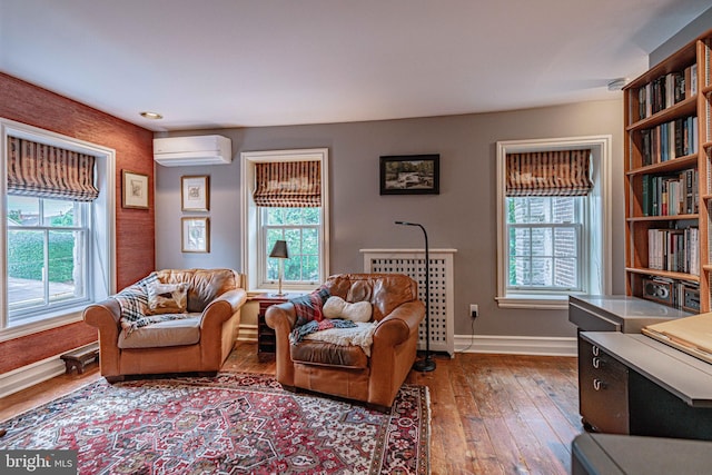 407 N 8th St, Allentown, PA 18102 - living room with a wall mounted AC, healthy amount of natural light, and hardwood / wood-style floors