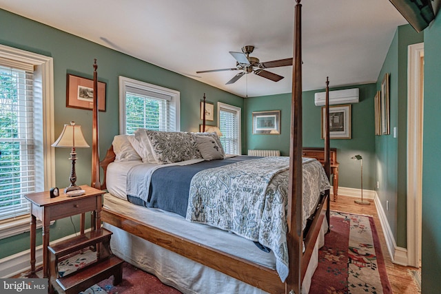 407 N 8th St, Allentown, PA 18102 - bedroom featuring a wall unit AC, wood finished floors, ceiling fan, and radiator