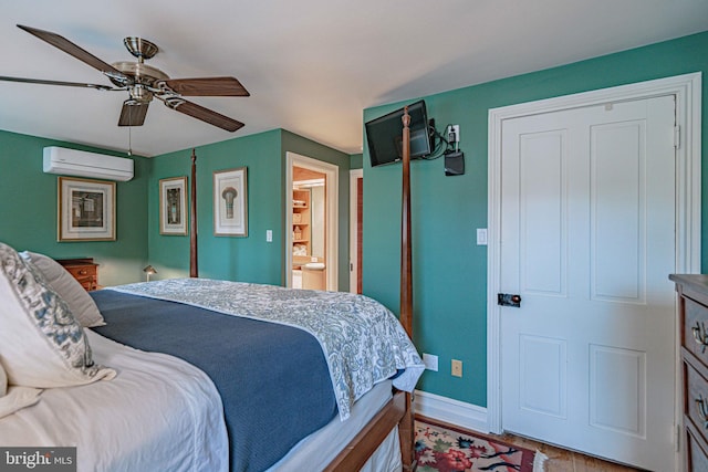 407 N 8th St, Allentown, PA 18102 - bedroom featuring a wall unit AC, wood finished floors, ceiling fan, and ensuite bathroom