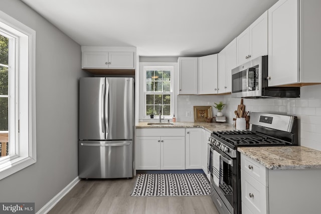 199 Erial, Pine Hill, NJ 08021 - kitchen featuring stainless steel appliances, plenty of natural light, light wood-style flooring, and decorative backsplash