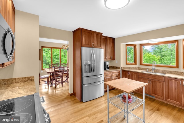 210 Providence Rd, Annapolis, MD 21409 - kitchen with appliances with stainless steel finishes, light wood finished floors, and brown cabinetry
