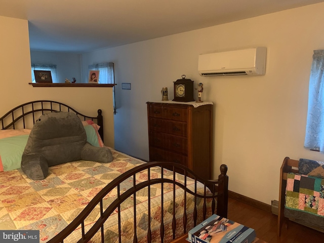 21055 Bayside Ave, Rock Hall, MD 21661 - bedroom featuring a wall mounted air conditioner and wood finished floors