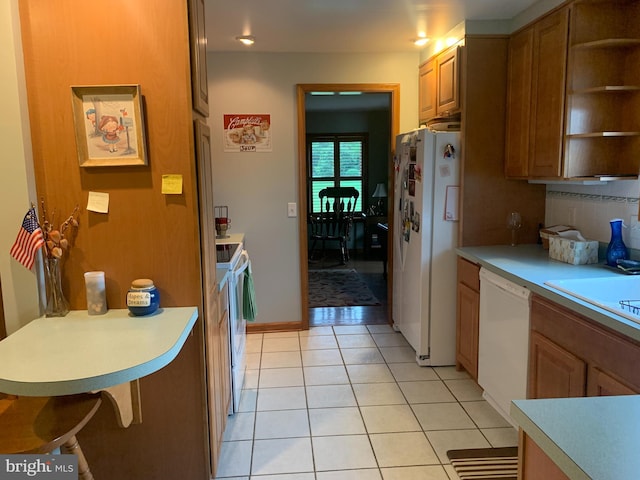 21055 Bayside Ave, Rock Hall, MD 21661 - kitchen featuring white appliances, open shelves, light tile patterned floors, light countertops, and brown cabinetry