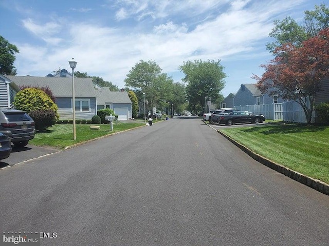 57 Turnberry Cir, Toms River, NJ 08753 - view of asphalt road featuring street lights, curbs, and a residential view