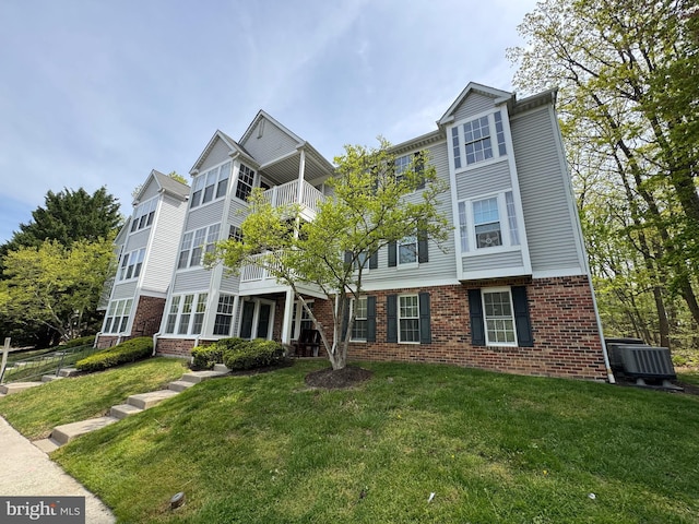 1305 Cedar Crest Ct Unit 1305-D, Edgewood, MD 21040 - view of front of property with brick siding, a front lawn, and a balcony
