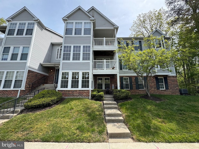 1305 Cedar Crest Ct Unit 1305-D, Edgewood, MD 21040 - view of front of home featuring brick siding, a balcony, and a front lawn