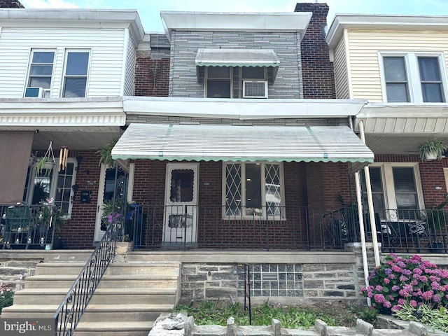 4066 Creston St, Philadelphia, PA 19135 - townhome / multi-family property with brick siding and a porch