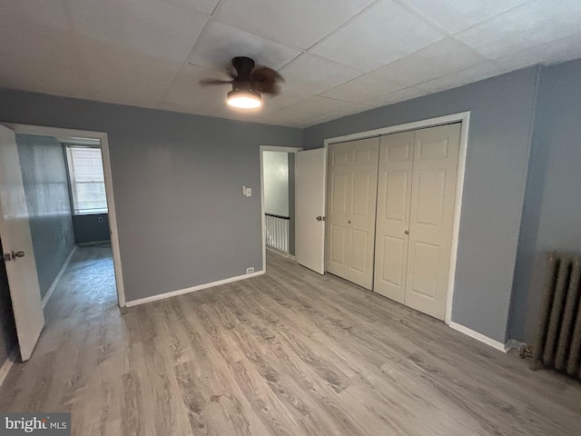 4066 Creston St, Philadelphia, PA 19135 - unfurnished bedroom featuring a paneled ceiling, radiator heating unit, light wood-type flooring, a closet, and ceiling fan