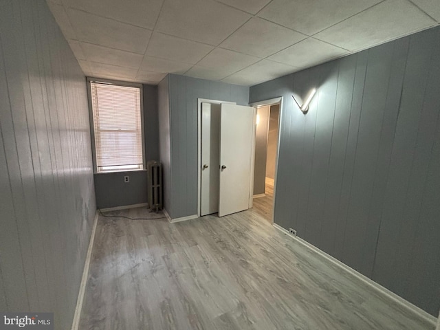 4066 Creston St, Philadelphia, PA 19135 - spare room featuring radiator, wood finished floors, and wood walls