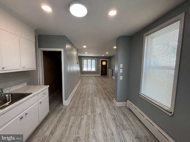 4066 Creston St, Philadelphia, PA 19135 - kitchen featuring baseboard heating, white cabinets, light countertops, light wood-style floors, and recessed lighting