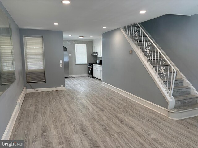 4066 Creston St, Philadelphia, PA 19135 - unfurnished living room featuring stairway, light wood-style floors, and recessed lighting