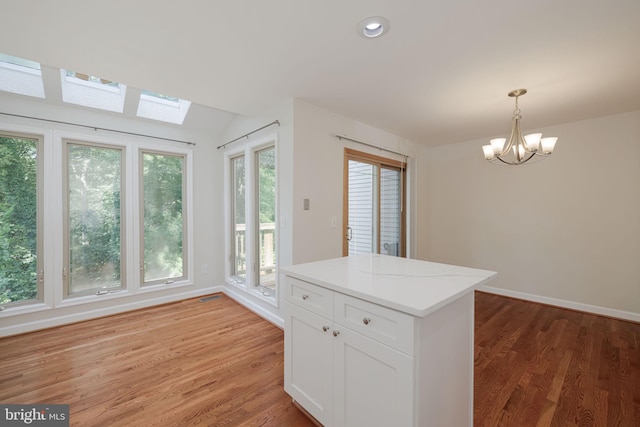 6110 Joust Ln, Alexandria, VA 22315 - kitchen featuring a chandelier, light wood finished floors, hanging light fixtures, white cabinets, and recessed lighting