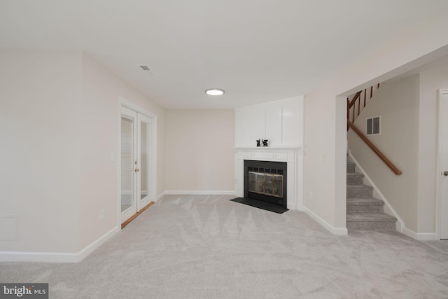6110 Joust Ln, Alexandria, VA 22315 - unfurnished living room with stairs, light colored carpet, and a fireplace