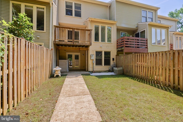 6110 Joust Ln, Alexandria, VA 22315 - rear view of property with a fenced backyard, french doors, and a balcony